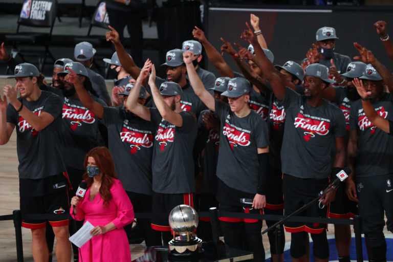 The Miami Heat applaud as they receive the Eastern Conference Championship trophy