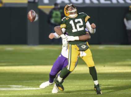 Green Bay Packers quarterback Aaron Rodgers fumbles the ball after being tackled by Minnesota Vikings defensive end D.J. Wonnum on Sunday.